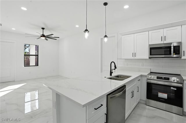 4881/4883 Leonard Blvd S, Lehigh Acres, FL 33973 - kitchen with stainless steel appliances, light marble finish flooring, a peninsula, recessed lighting, and light stone countertops