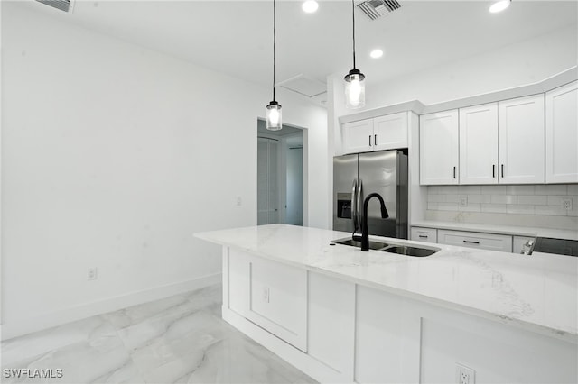 4881/4883 Leonard Blvd S, Lehigh Acres, FL 33973 - kitchen with stainless steel refrigerator with ice dispenser, recessed lighting, white cabinets, decorative light fixtures, and light stone counters