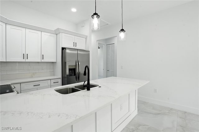4881/4883 Leonard Blvd S, Lehigh Acres, FL 33973 - kitchen with stainless steel fridge with ice dispenser, hanging light fixtures, white cabinetry, light stone counters, and recessed lighting