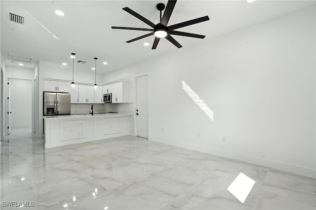 4881/4883 Leonard Blvd S, Lehigh Acres, FL 33973 - kitchen with stainless steel appliances, open floor plan, recessed lighting, white cabinetry, and light marble finish floors