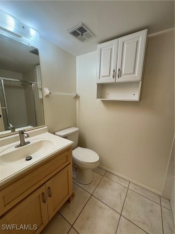 1069 Villa Dr Unit B103, Labelle, FL 33935 - bathroom with vanity, a shower with door, and tile patterned flooring