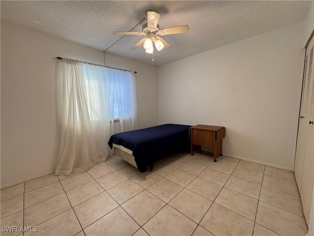 1069 Villa Dr Unit B103, Labelle, FL 33935 - bedroom featuring light tile patterned floors, a textured ceiling, and ceiling fan