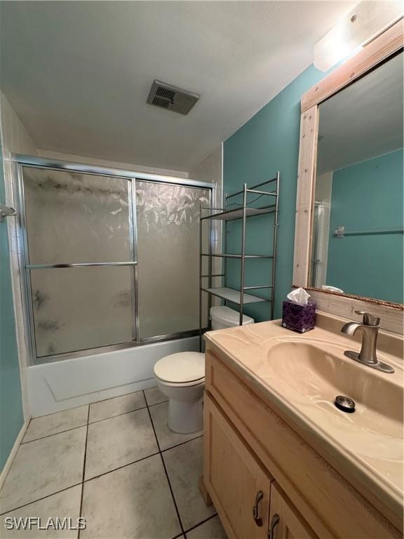 1069 Villa Dr Unit B103, Labelle, FL 33935 - full bathroom with vanity, combined bath / shower with glass door, and tile patterned floors