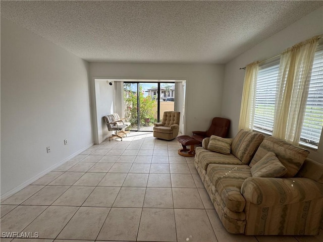 1069 Villa Dr Unit B103, Labelle, FL 33935 - living room featuring a textured ceiling and light tile patterned flooring