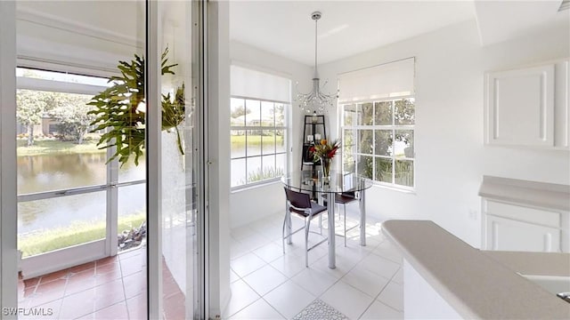 2115 Arielle Dr Unit 2602, Naples, FL 34109 - dining area with a water view, a chandelier, and light tile patterned floors