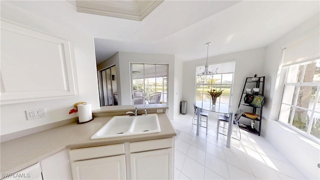2115 Arielle Dr Unit 2602, Naples, FL 34109 - kitchen featuring light tile patterned flooring, white cabinetry, light countertops, and hanging light fixtures