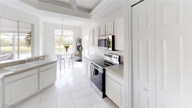 2115 Arielle Dr Unit 2602, Naples, FL 34109 - kitchen featuring appliances with stainless steel finishes, a chandelier, light tile patterned floors, and light countertops
