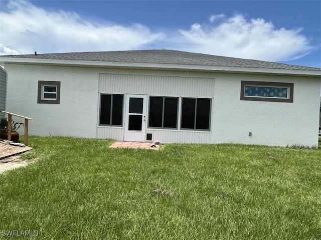 7005 Berwick Cir, Labelle, FL 33935 - rear view of house with a lawn and a shingled roof