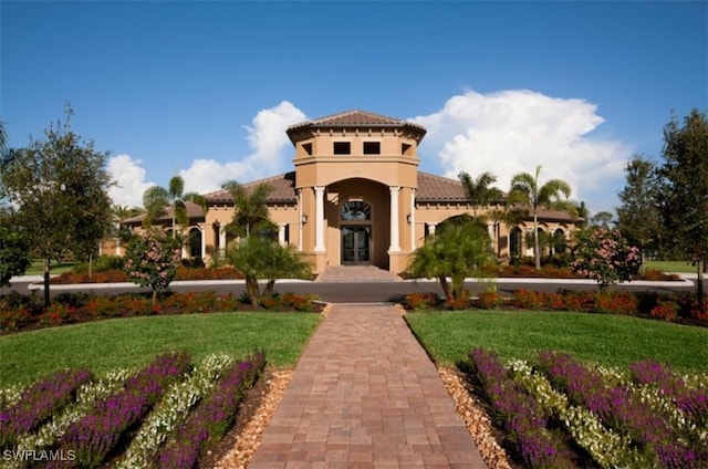 23056 Sanabria Loop, Bonita Springs, FL 34135 - view of front facade with stucco siding and a front yard