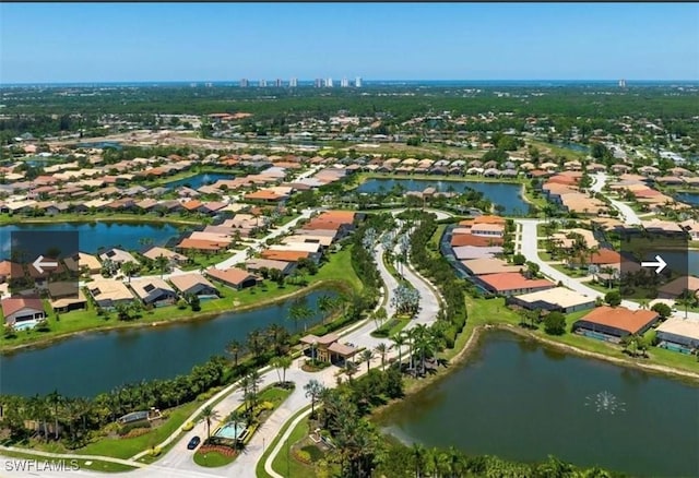 23056 Sanabria Loop, Bonita Springs, FL 34135 - aerial view of property and surrounding area with nearby suburban area and a large body of water
