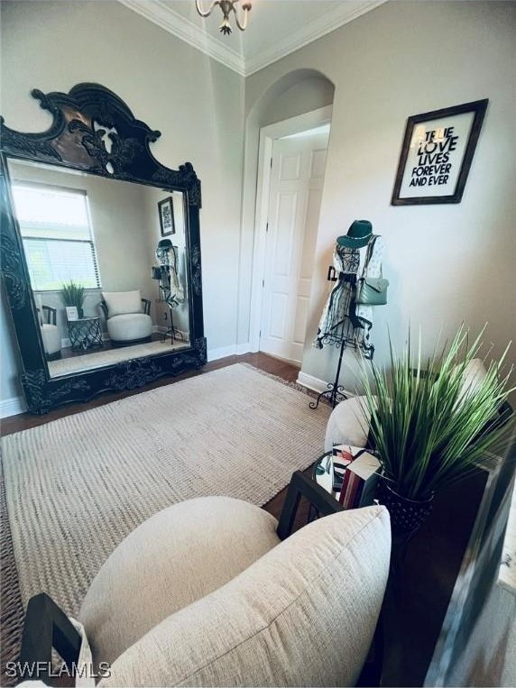23056 Sanabria Loop, Bonita Springs, FL 34135 - living room featuring crown molding, wood finished floors, and arched walkways