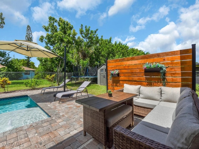 446 SW 19th Ter, Cape Coral, FL 33991 - fenced backyard featuring a trampoline, a patio area, an outdoor living space, and a storage shed
