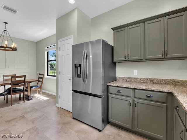 446 SW 19th Ter, Cape Coral, FL 33991 - kitchen with stainless steel refrigerator with ice dispenser, a chandelier, pendant lighting, and green cabinetry