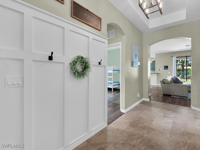 446 SW 19th Ter, Cape Coral, FL 33991 - mudroom with arched walkways, marble look tiles, and a chandelier
