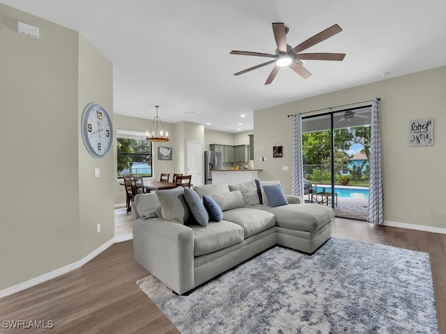 446 SW 19th Ter, Cape Coral, FL 33991 - living room featuring a ceiling fan, wood finished floors, a chandelier, healthy amount of natural light, and recessed lighting