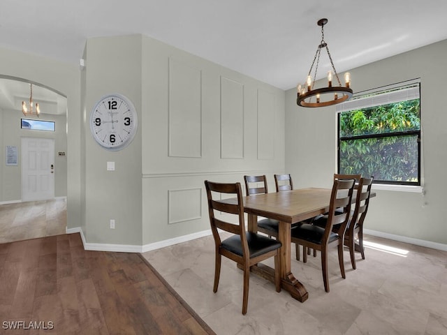 446 SW 19th Ter, Cape Coral, FL 33991 - dining room with a chandelier, light wood-style floors, and arched walkways