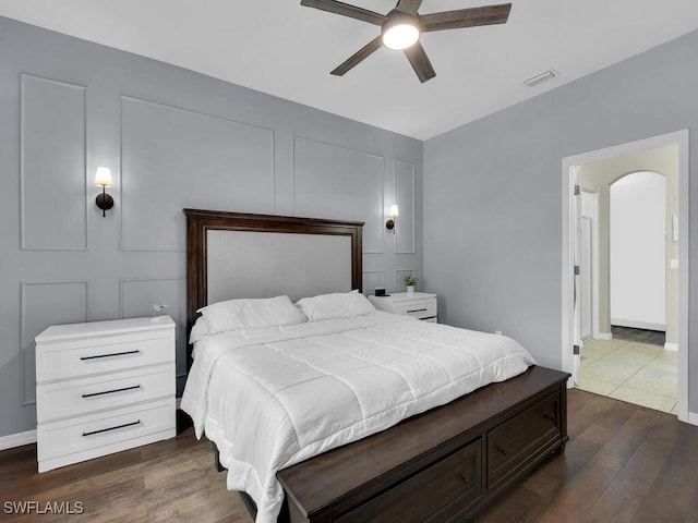 446 SW 19th Ter, Cape Coral, FL 33991 - bedroom featuring dark wood finished floors, arched walkways, and a ceiling fan