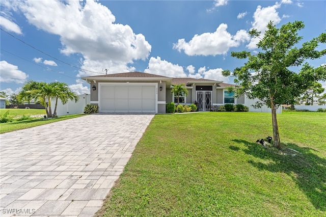 2909 NW 24th Ave, Cape Coral, FL 33993 - single story home with stucco siding, decorative driveway, a garage, and a front lawn