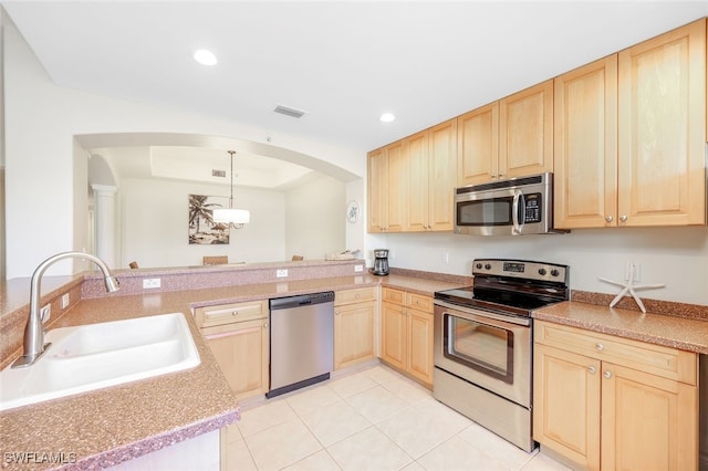 1128 Manor Lake Dr Unit G103, Naples, FL 34110 - kitchen featuring stainless steel appliances, light brown cabinetry, arched walkways, recessed lighting, and light tile patterned floors