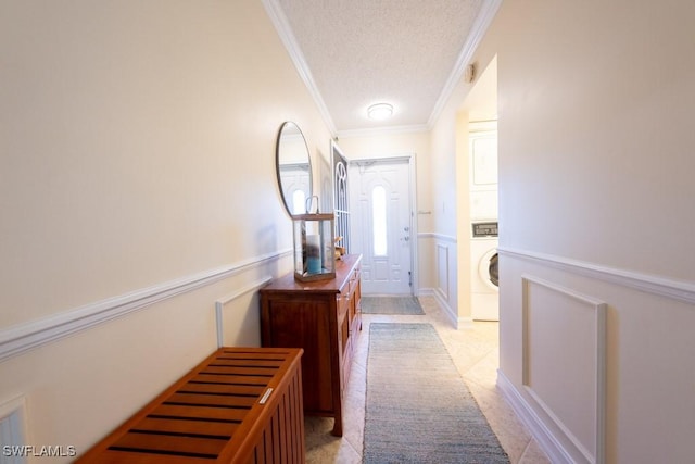 325 Charlemagne Blvd Unit C204, Naples, FL 34112 - corridor featuring a textured ceiling, stacked washer and clothes dryer, crown molding, wainscoting, and light tile patterned floors