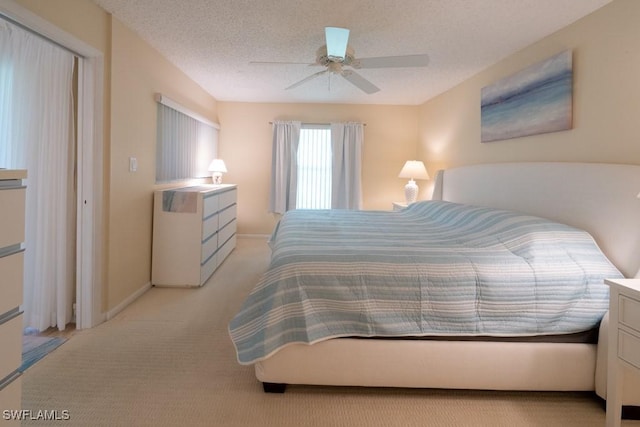 325 Charlemagne Blvd Unit C204, Naples, FL 34112 - bedroom featuring light colored carpet, ceiling fan, and a textured ceiling