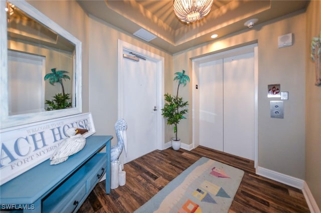 4182 Bay Beach Ln Unit 746, Fort Myers Beach, FL 33931 - foyer entrance with a tray ceiling, elevator, dark wood finished floors, and a chandelier