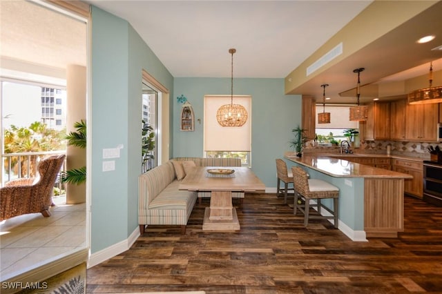 4182 Bay Beach Ln Unit 746, Fort Myers Beach, FL 33931 - dining area with dark wood finished floors and a chandelier