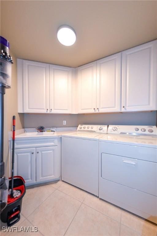 4182 Bay Beach Ln Unit 746, Fort Myers Beach, FL 33931 - laundry room featuring cabinet space, washing machine and clothes dryer, and light tile patterned floors