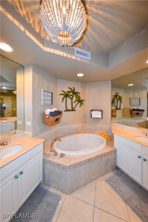 4182 Bay Beach Ln Unit 746, Fort Myers Beach, FL 33931 - full bath with two vanities, a garden tub, tile patterned flooring, and a chandelier