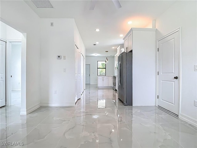 3705 8th St SW, Lehigh Acres, FL 33976 - hallway featuring light marble finish floors and recessed lighting