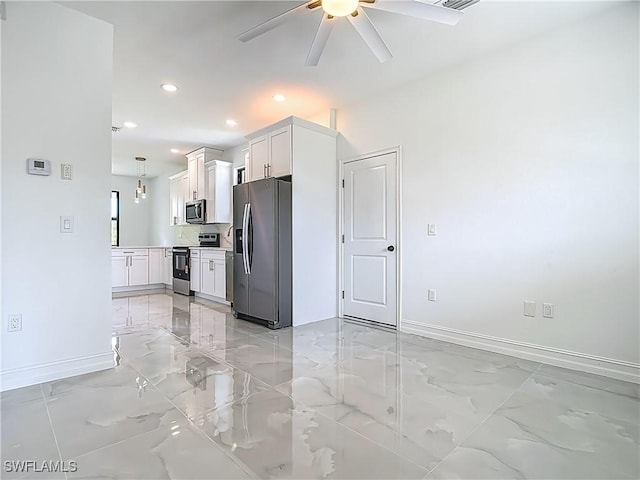 3705 8th St SW, Lehigh Acres, FL 33976 - kitchen featuring stainless steel appliances, light marble finish floors, a ceiling fan, white cabinets, and light countertops