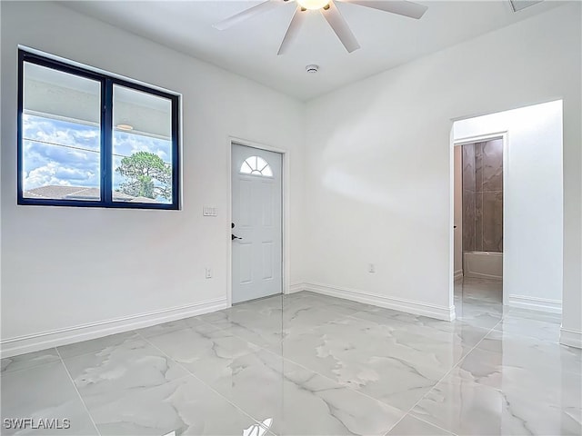 3705 8th St SW, Lehigh Acres, FL 33976 - spare room with light marble finish floors and ceiling fan
