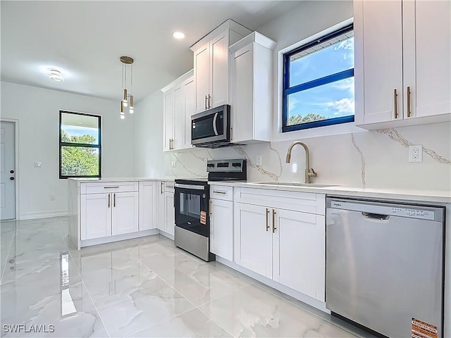 3705 8th St SW, Lehigh Acres, FL 33976 - kitchen featuring stainless steel appliances, a peninsula, light marble finish floors, white cabinetry, and light countertops