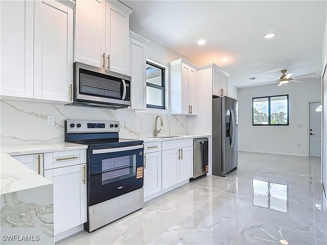 3705 8th St SW, Lehigh Acres, FL 33976 - kitchen with appliances with stainless steel finishes, backsplash, white cabinets, a ceiling fan, and recessed lighting
