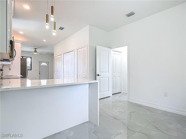 3705 8th St SW, Lehigh Acres, FL 33976 - kitchen with light marble finish flooring, a ceiling fan, recessed lighting, stainless steel appliances, and decorative light fixtures