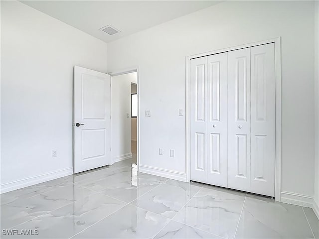 3705 8th St SW, Lehigh Acres, FL 33976 - unfurnished bedroom with light marble finish floors and a closet