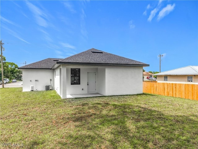 3705 8th St SW, Lehigh Acres, FL 33976 - rear view of house with roof with shingles, stucco siding, and a patio