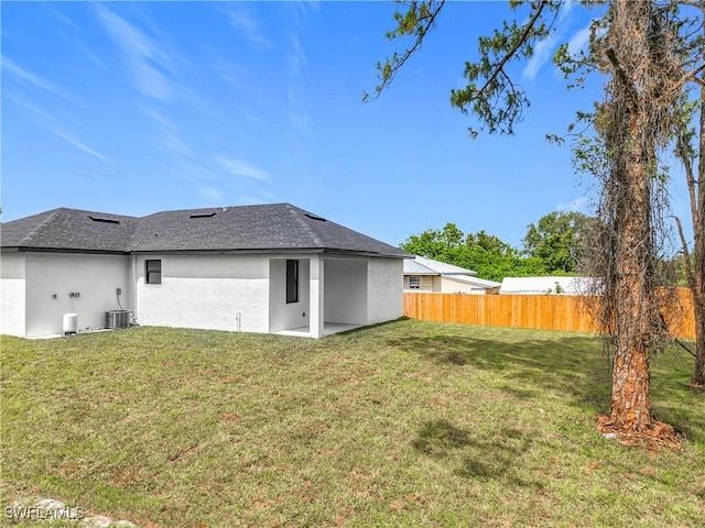 3705 8th St SW, Lehigh Acres, FL 33976 - rear view of house with stucco siding and a shingled roof