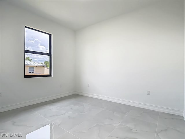 3705 8th St SW, Lehigh Acres, FL 33976 - unfurnished room featuring light marble finish flooring
