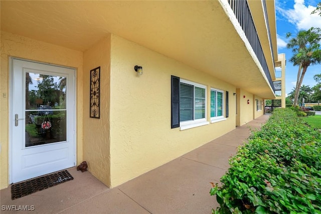 1086 Forest Lakes Dr Unit 9106, Naples, FL 34105 - doorway to property with stucco siding