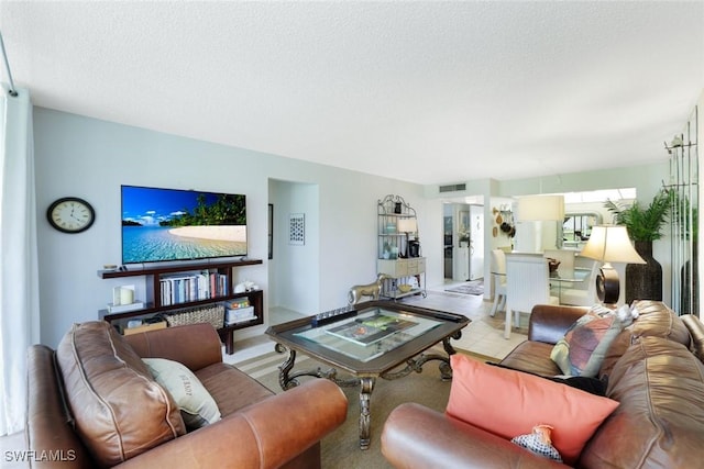 1086 Forest Lakes Dr Unit 9106, Naples, FL 34105 - living room featuring a textured ceiling