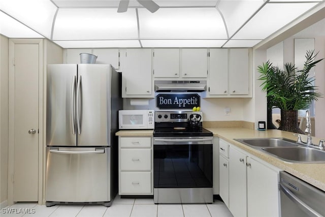 1086 Forest Lakes Dr Unit 9106, Naples, FL 34105 - kitchen featuring appliances with stainless steel finishes, under cabinet range hood, light countertops, light tile patterned floors, and ceiling fan