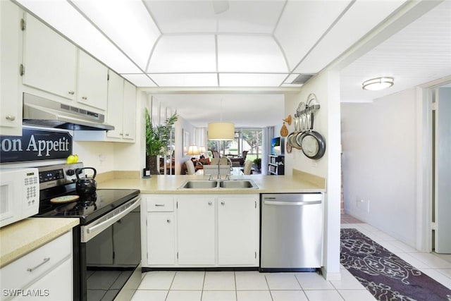 1086 Forest Lakes Dr Unit 9106, Naples, FL 34105 - kitchen with stainless steel appliances, under cabinet range hood, light countertops, and light tile patterned flooring