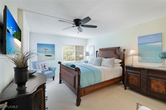1086 Forest Lakes Dr Unit 9106, Naples, FL 34105 - bedroom with light colored carpet, a ceiling fan, and a textured ceiling