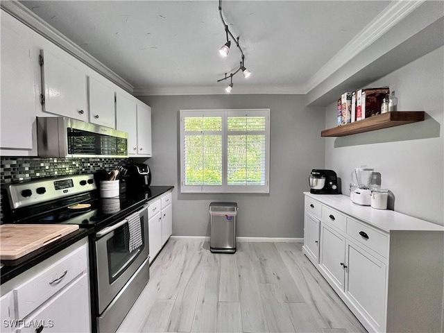 34 Glades Blvd Unit 1461, Naples, FL 34112 - kitchen featuring stainless steel appliances, crown molding, tasteful backsplash, white cabinets, and rail lighting