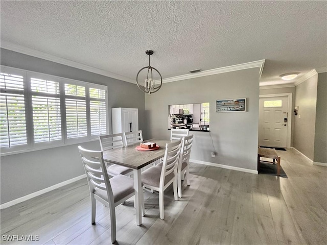 34 Glades Blvd Unit 1461, Naples, FL 34112 - dining area featuring light wood finished floors, plenty of natural light, crown molding, a textured ceiling, and a chandelier