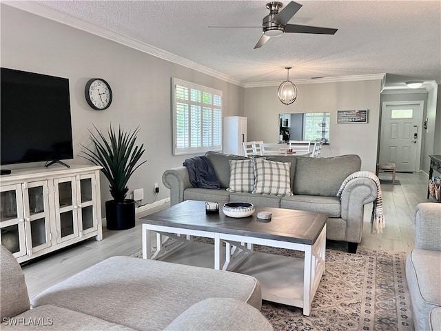 34 Glades Blvd Unit 1461, Naples, FL 34112 - living room featuring a ceiling fan, light wood-type flooring, crown molding, and a textured ceiling