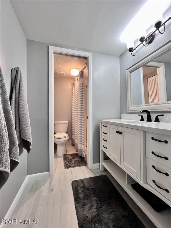34 Glades Blvd Unit 1461, Naples, FL 34112 - bathroom featuring vanity, wood finished floors, and a shower with shower curtain