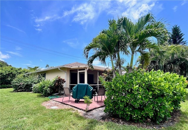 34 Glades Blvd Unit 1461, Naples, FL 34112 - rear view of property with a lawn, stucco siding, and a sunroom