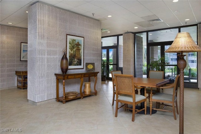 440 Seaview Ct Unit 1106, Marco Island, FL 34145 - dining room with healthy amount of natural light, a wall of windows, tile patterned floors, recessed lighting, and wallpapered walls
